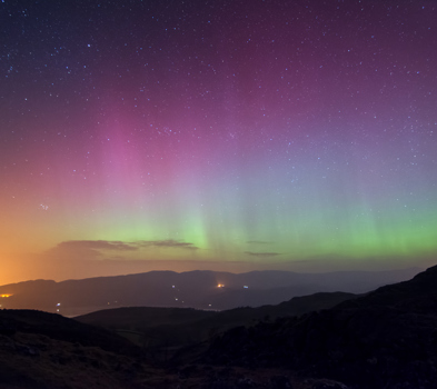 Aurora Borealis visible with the naked eye in Snowdonia overlooking Barmouth Estuary 